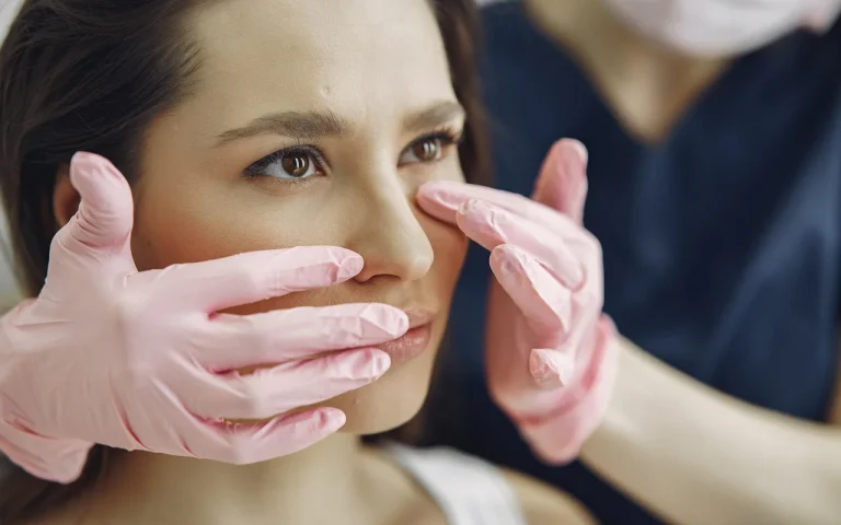 doctor examining the young female patient's face